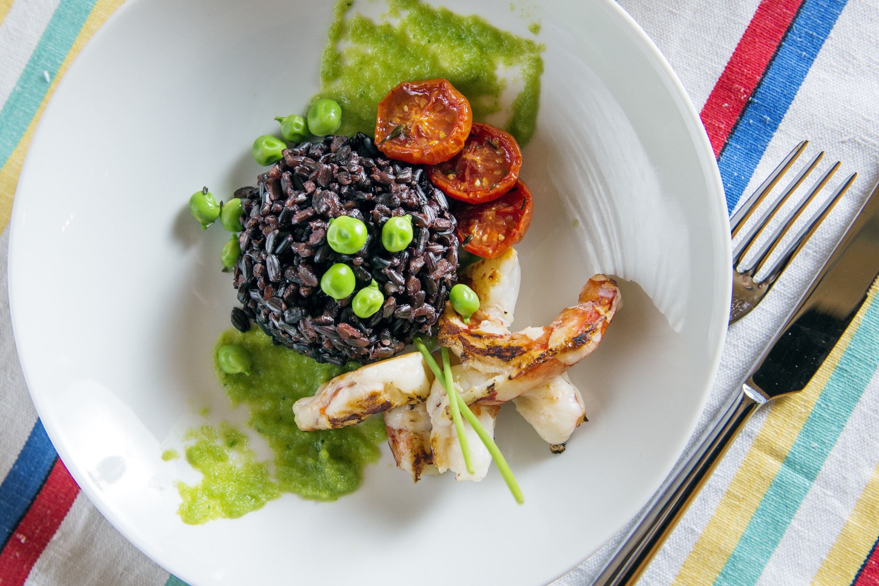 Black Venus rice with caramelised cherry tomatoes, peas and prawns - Bertazzoni